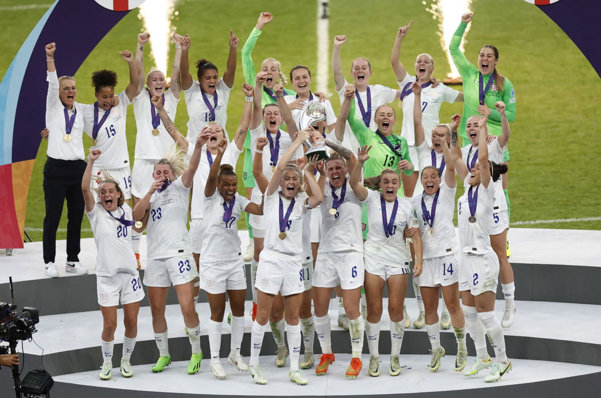<i>Peter Cziborra/Reuters via CNN Newsource</i><br/>England's Leah Williamson and Millie Bright lift the trophy as they celebrate with teammates after winning Women's Euro 2022.