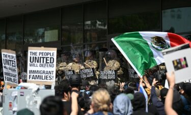 Demonstrators face California National Guard members standing guard outside the Federal Building during a protest in response to federal immigration operations in Los Angeles