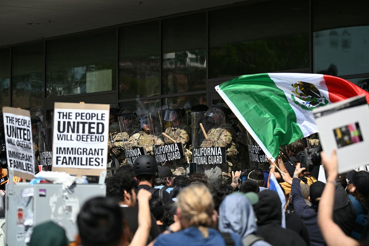 <i>Ronaldo Schemidt/AFP/Getty Images via CNN Newsource</i><br/>Demonstrators face California National Guard members standing guard outside the Federal Building during a protest in response to federal immigration operations in Los Angeles