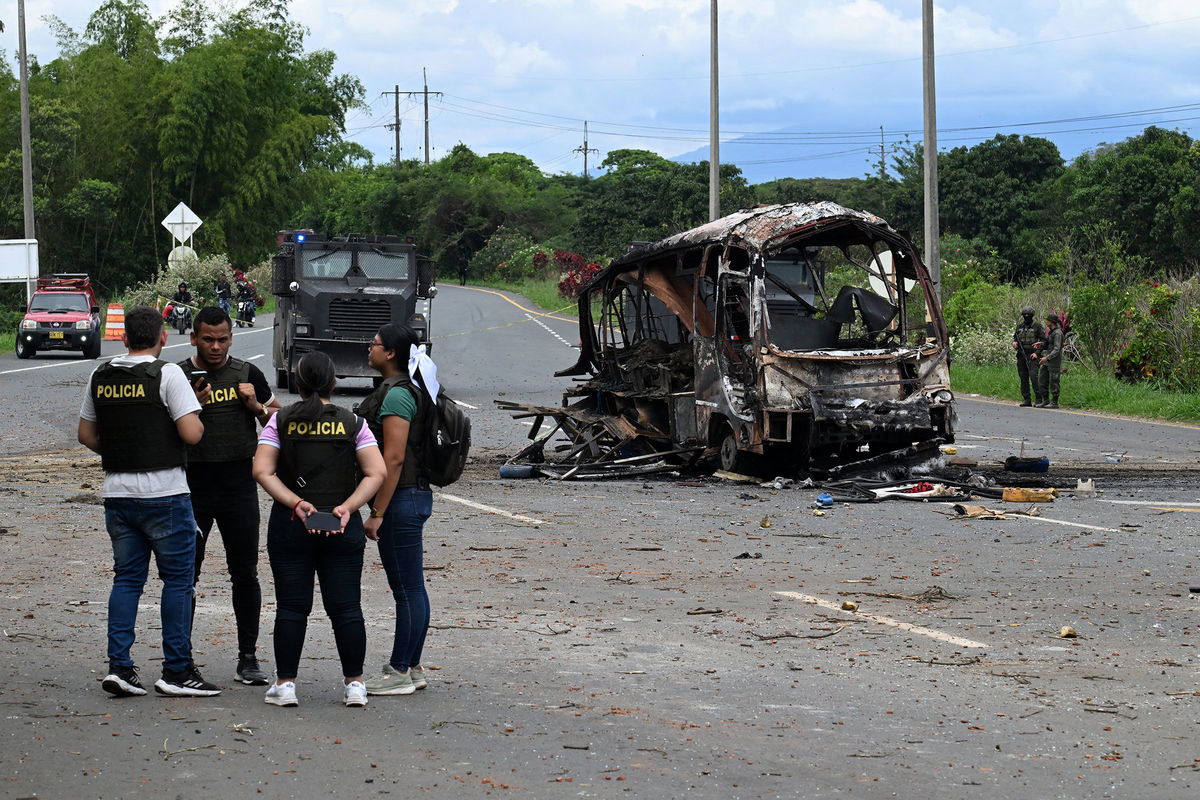 <i>Joaquin Sarmiento/AFP/Getty Images via CNN Newsource</i><br/>Police officers work at the site where a bus exploded in front of a police station in Villa Rica