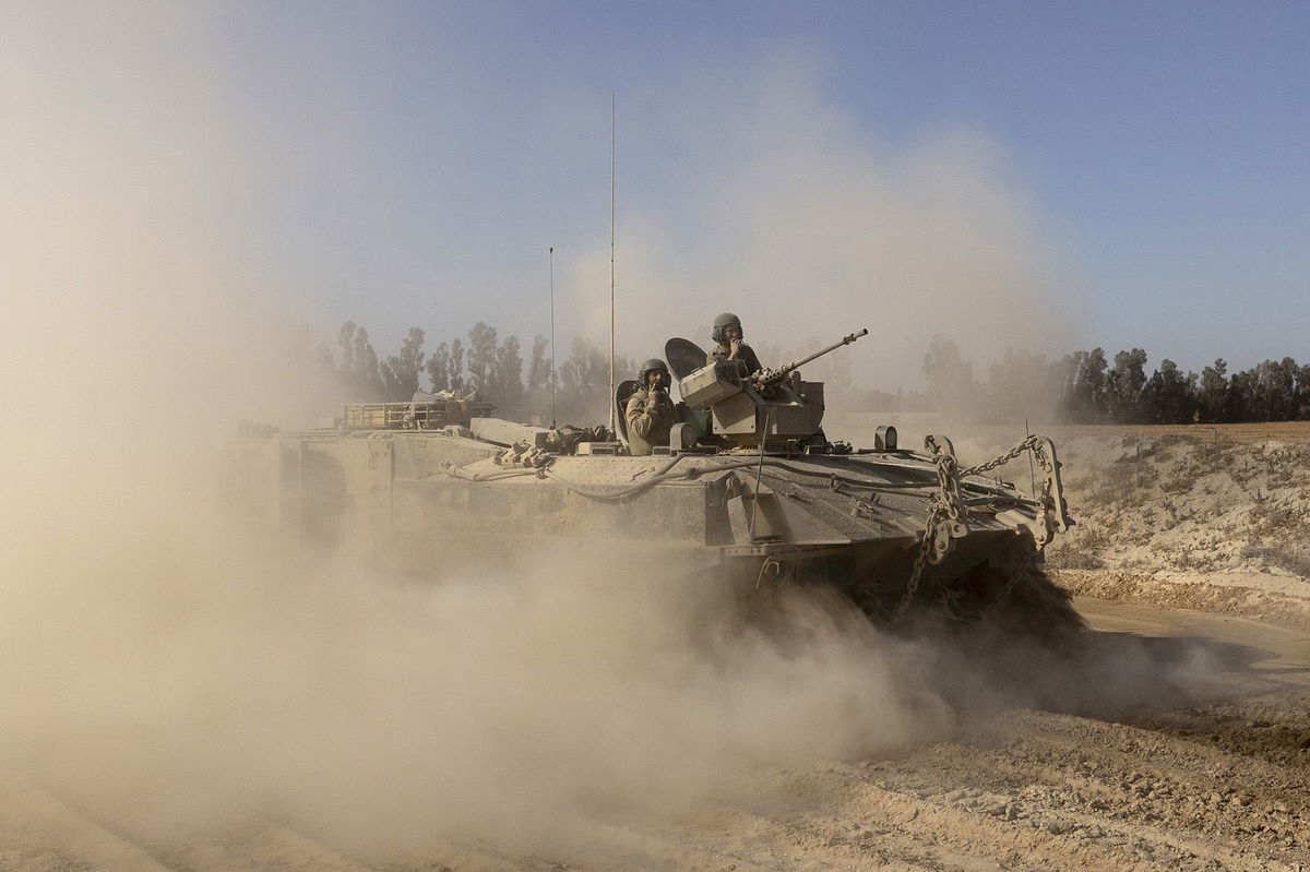 <i>Amir Levy/Getty Images via CNN Newsource</i><br/>Israeli soldiers stand on an armored personnel carrier as they move near the border with the Gaza Strip as seen from a position on the Israeli side of the border