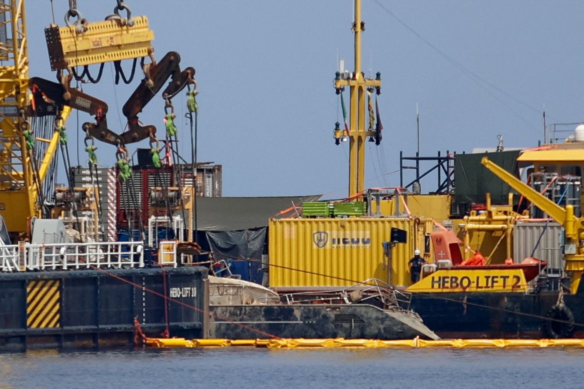 <i>Igor Petyx/Reuters via CNN Newsource</i><br/>Floating crane ships HEBO LIFT 10 and HEBO LIFT 2 recover the 