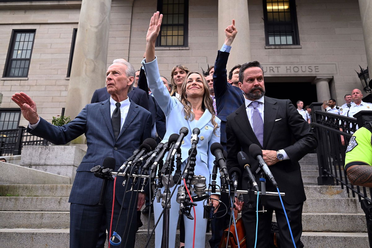 <i>Pat Greenhouse/The Boston Globe/Getty Images via CNN Newsource</i><br/>Karen Read supporters cheer for her outside Norfolk Superior Court on June 18. One sign holder implores people not to forget John O'Keefe after the jury delivered its verdict in her murder retrial.