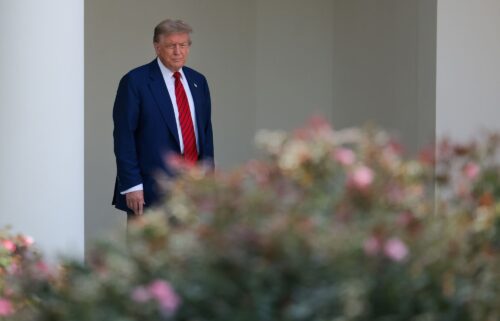 President Donald Trump walks out of the Oval Office and views the Rose Garden construction before boarding Marine One on the South Lawn of the White House on Friday