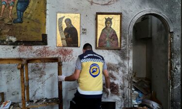 A member of the Syrian security force inspects the damage after a reported attack at the Mar Elias Church in the Dweila neighbourhood of Damascus