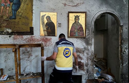 A member of the Syrian security force inspects the damage after a reported attack at the Mar Elias Church in the Dweila neighbourhood of Damascus