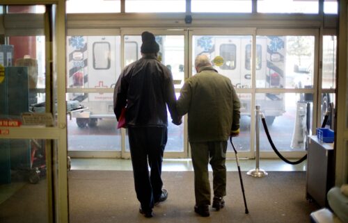 A patient is assisted out of the emergency department at a hospital in Atlanta.