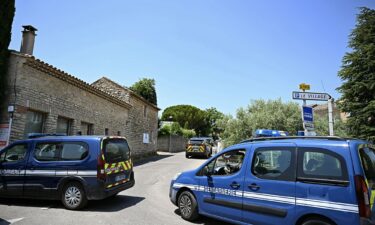 French law enforcement vehicles form a perimeter around the site of the shooting in the village of Goult.