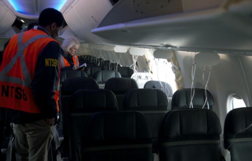 Members of the NTSB examine the hole in the fuselage plug area of Alaska Airlines Boeing 737 Max flight in which a door plug blew out in January 2024.