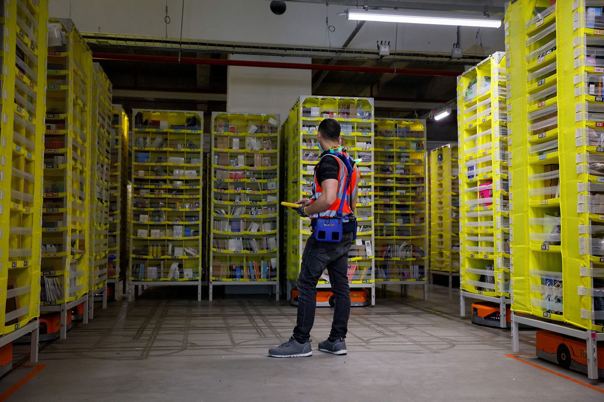 <i>Thomas Samson/AFP/Getty Images via CNN Newsource</i><br/>A maintenance employee works in a robotic warehouse at Amazon's centre of Bretigny-sur-Orge