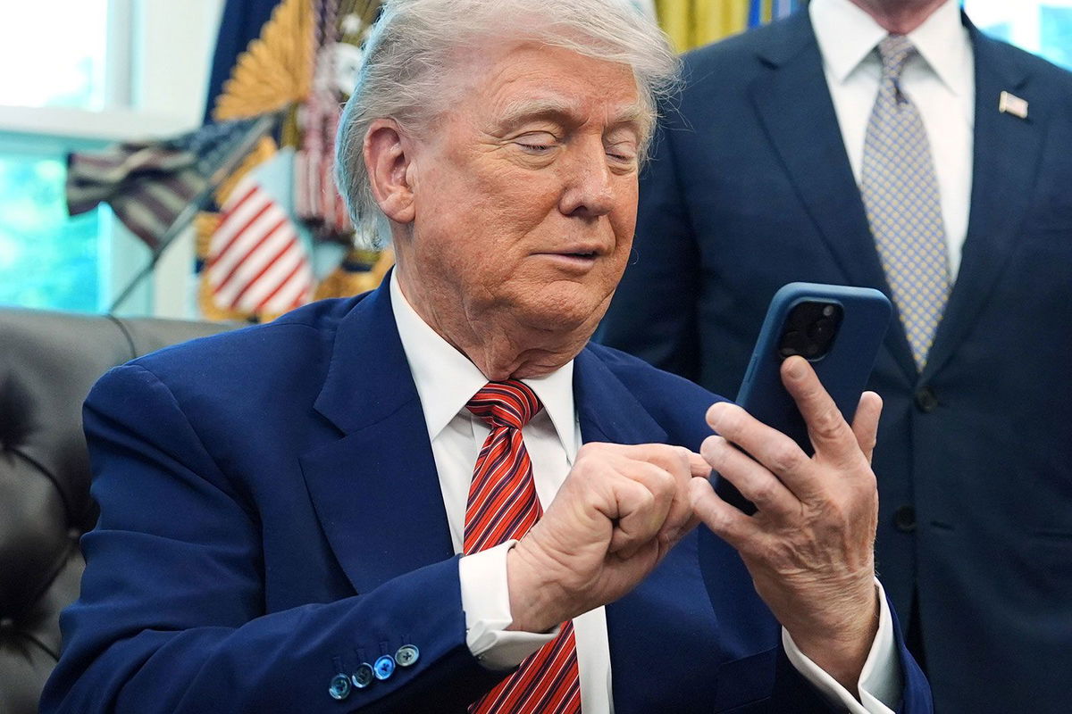 <i>Evan Vucci/AP/File via CNN Newsource</i><br/>President Donald Trump silences his mobile phone.