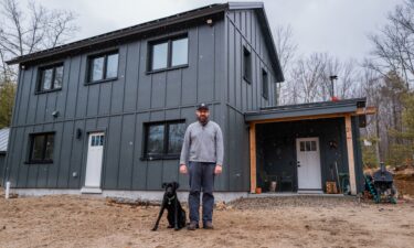 Workers install windows and doors in one Unity home panel.