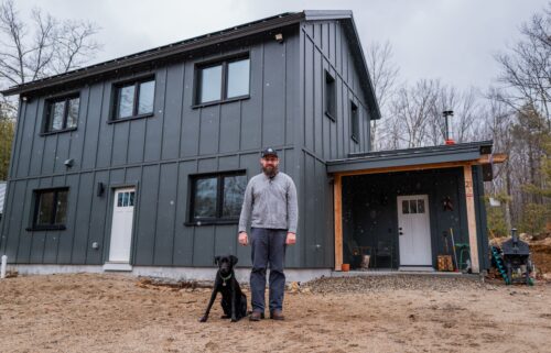 Workers install windows and doors in one Unity home panel.