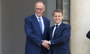 French President Emmanuel Macron speaks with Germany's Chancellor Friedrich Merz before a meeting on the sidelines of the NATO summit in The Hague