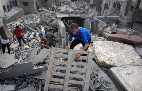 Palestinians search for survivors from the rubble of a home that was hit by an Israeli strike