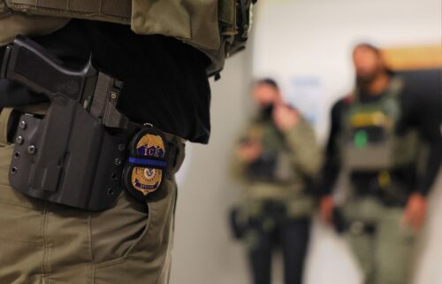 An ICE officer's badge is seen as federal agents patrol the halls of immigration court at the Jacob K. Javitz Federal Building in New York City.