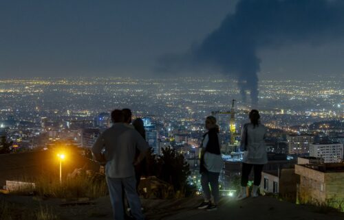 Iranian people gather at the scene of an explosion at a residential complex due to Israeli attacks in Tehran