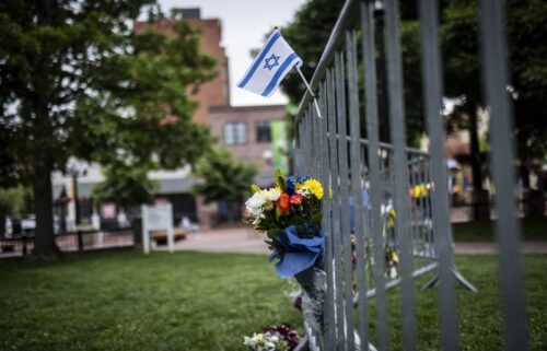Flowers and a flag at the site of the attack outside the Boulder County Courthouse in Boulder
