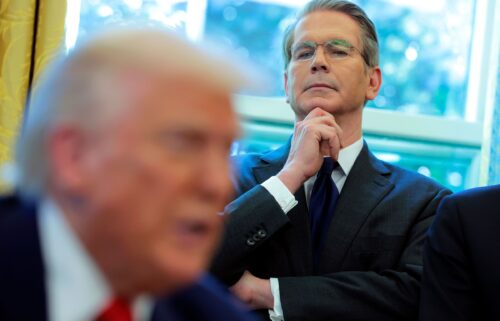 Treasury Secretary Scott Bessent looks on as President Donald Trump signs executive orders in the Oval Office.