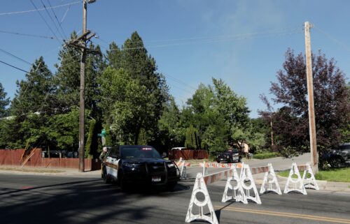 Kootenai County Sheriff’s deputies block a road leading to an area where multiple firefighters were attacked.