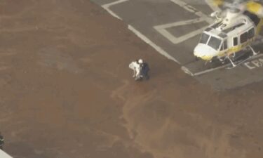 Firefighters rescued five people after a flash flood in the San Gabriel Mountains swept them away.