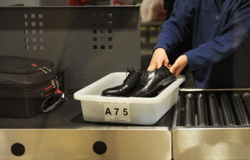 An air traveler places his shoes in a bin before passing through a TSA checkpoint at Los Angeles International Airport in 2014.