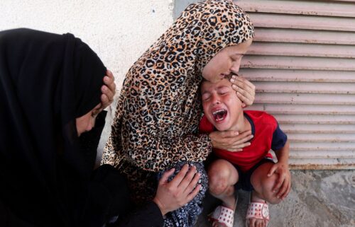 Relatives mourn over the bodies of Manal Abd Rabbo and her sister Fatima