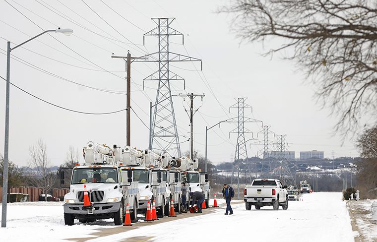 <i>Ron Jenkins/Getty Images via CNN Newsource</i><br/>Pike Electric service trucks line up after a snow storm on February 16