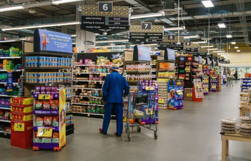 Shoppers walk the aisles of a Kroger supermarket on October 14