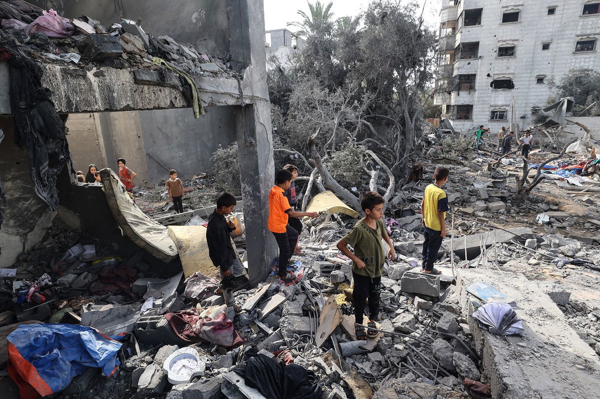 <i>Eyad Baba/AFP/Getty Images via CNN Newsource</i><br/>Palestinian children check the rubble of a residential house in Deir el-Balah in the central Gaza Strip on July 1