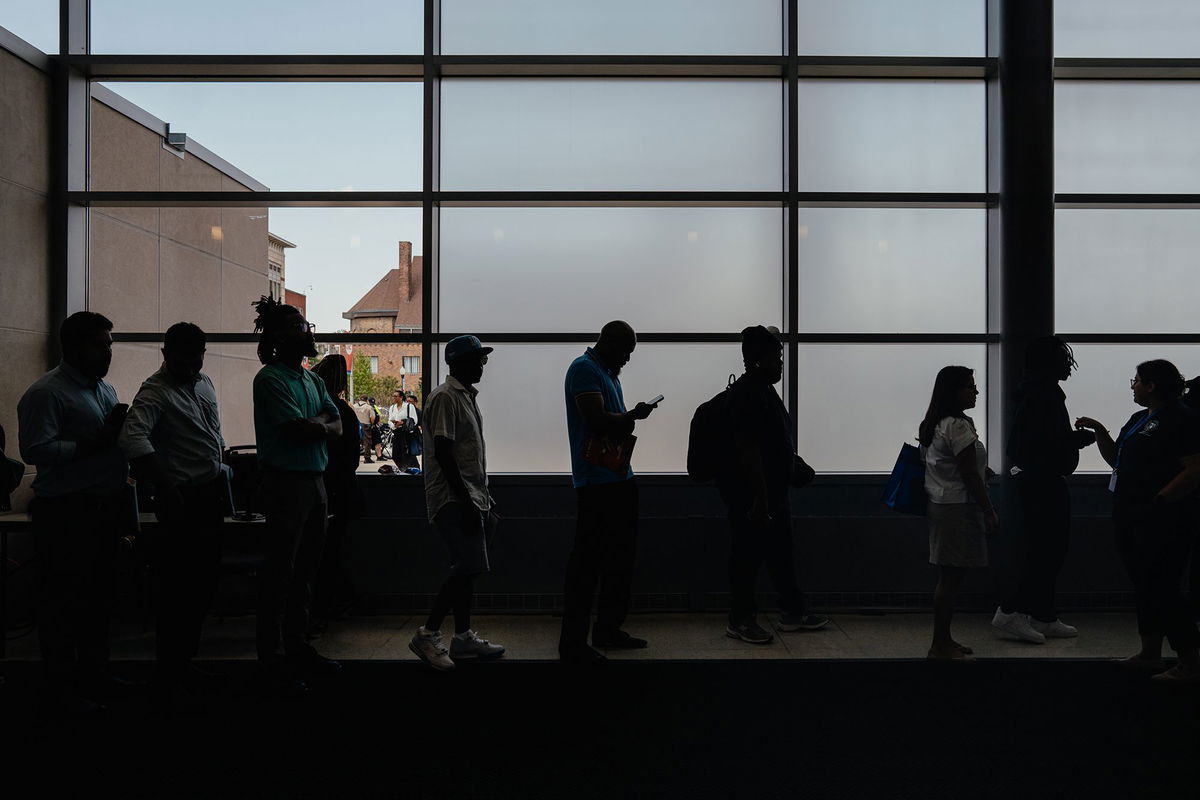 <i>Jamie Kelter Davis/Bloomberg/Getty Images via CNN Newsource</i><br/>Job seekers wait in line to enter an auditorium for a job fair hosted by the Cook County government to support federal workers in Chicago