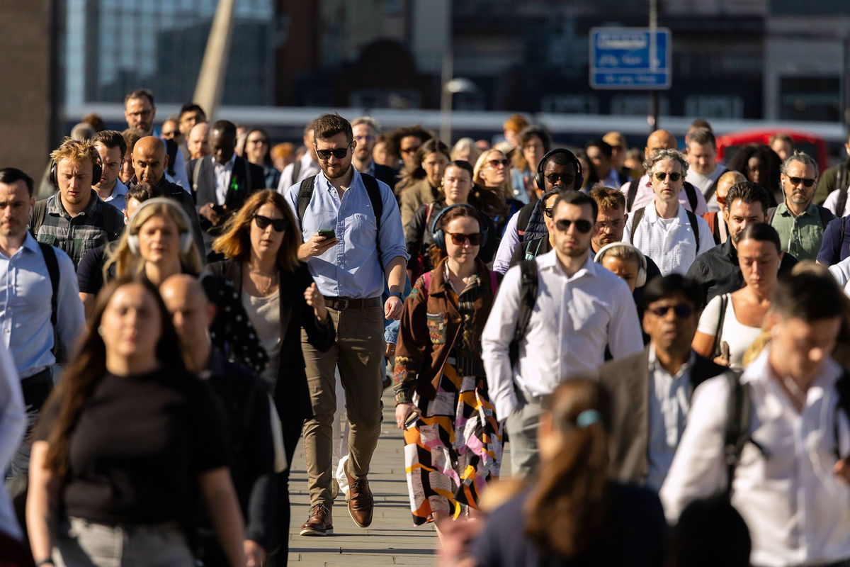 <i>Jason Alden/Bloomberg/Getty Images via CNN Newsource</i><br/>Commuters cross London Bridge in London on Wednesday