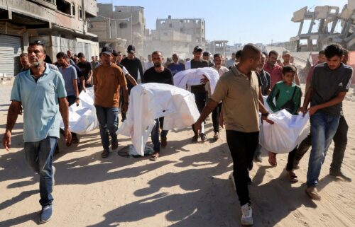 Mourners carry the bodies of Palestinians who were killed in an overnight Israeli strike