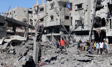 Palestinians inspect the damage after an Israeli strike in the Al-Bureij camp in central Gaza on July 4.