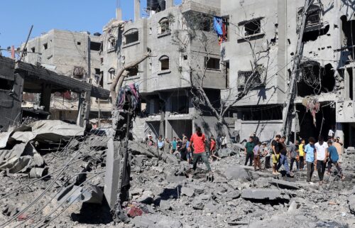 Palestinians inspect the damage after an Israeli strike in the Al-Bureij camp in central Gaza on July 4.