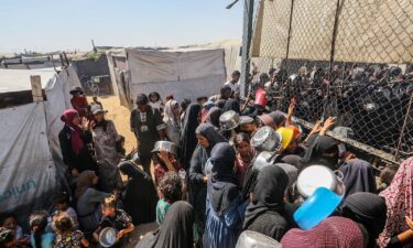 Palestinians gather to receive food on July 3