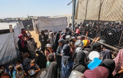Palestinians gather to receive food on July 3
