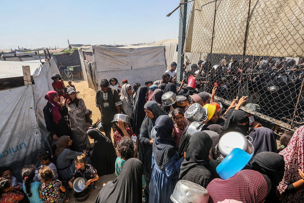 <i>Abed Rahim Khatib/Anadolu/Getty Images via CNN Newsource</i><br/>Palestinians gather to receive food on July 3