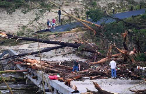 Debris covers a bridge over the Guadalupe River after a flash flood swept through the area in Ingram