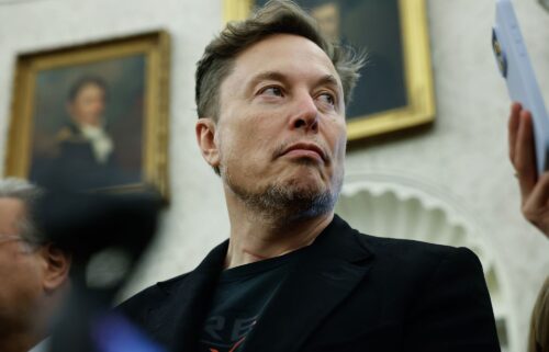 Elon Musk listens during a press availability in the Oval Office at the White House on May 21 in Washington