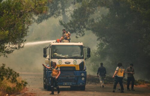 Smoke rises into the sky during a wildfire in the town of Rabia