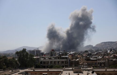 Smoke rises after strikes on Syria's defense ministry in Damascus on July 16.