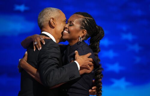 Former U.S. President Barack Obama (L) greets former first lady Michelle Obama as he arrives to speak on stage during the second day of the Democratic National Convention at the United Center on August 20