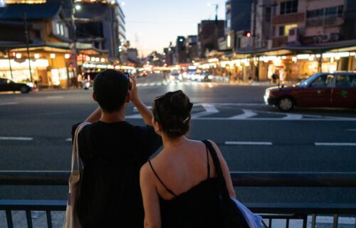 People cross the iconic Shibuya crossroads on June 17 in Tokyo