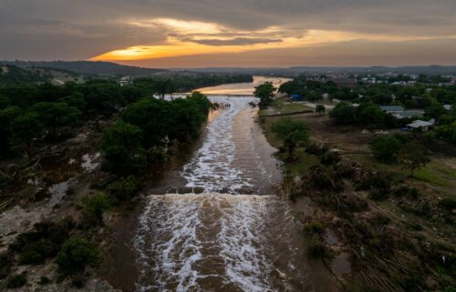 The sun sets over the swollen Guadalupe River in Kerrville