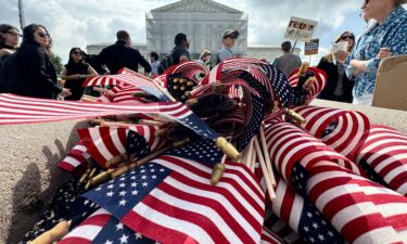 American flags are seen during a protest outside the US Supreme Court over President Donald Trump's move to end birthright citizenship as the court hears arguments over the order in Washington