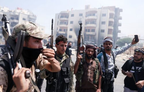 Syrian government security forces man a checkpoint along a road in southern Syria's Suwayda province.