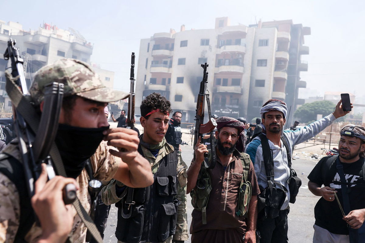 <i>Sam Hariri/AFP/Getty Images via CNN Newsource</i><br/>Syrian government security forces man a checkpoint along a road in southern Syria's Suwayda province.