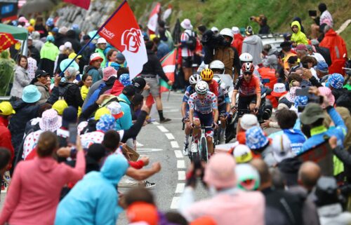 Spectators react as riders compete in the Tour de France's 14th stage.