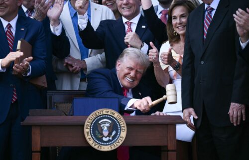 President Donald Trump bangs a gavel after signing a sweeping tax and spending cuts package he called his "big